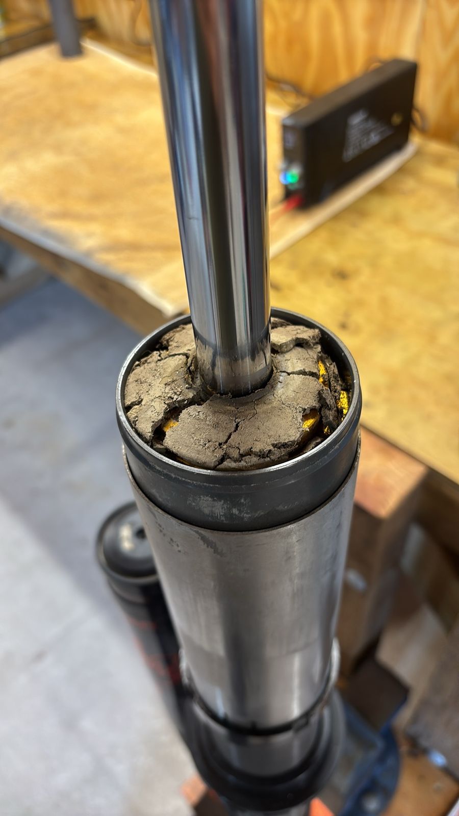 Shock seal head packed with dried mud and sand after riding